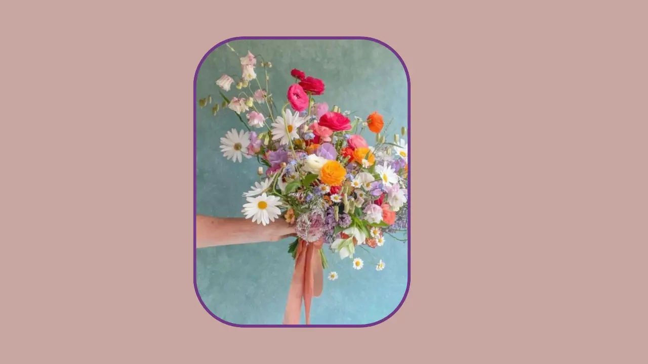 Hand holding colorful flower bouquet